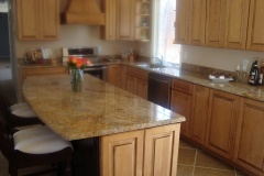 Granite island with support brackets for seating.