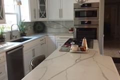 Ogee edge on Quartz island with full height splash.