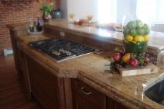 Two layer thick island with half bullnose edge with bump-out and bar top.