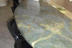 Free form granite countertop for seating.