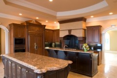 Two layer thick island with ogee edge in granite kitchen.